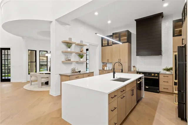 a kitchen with a sink stainless steel appliances and furniture