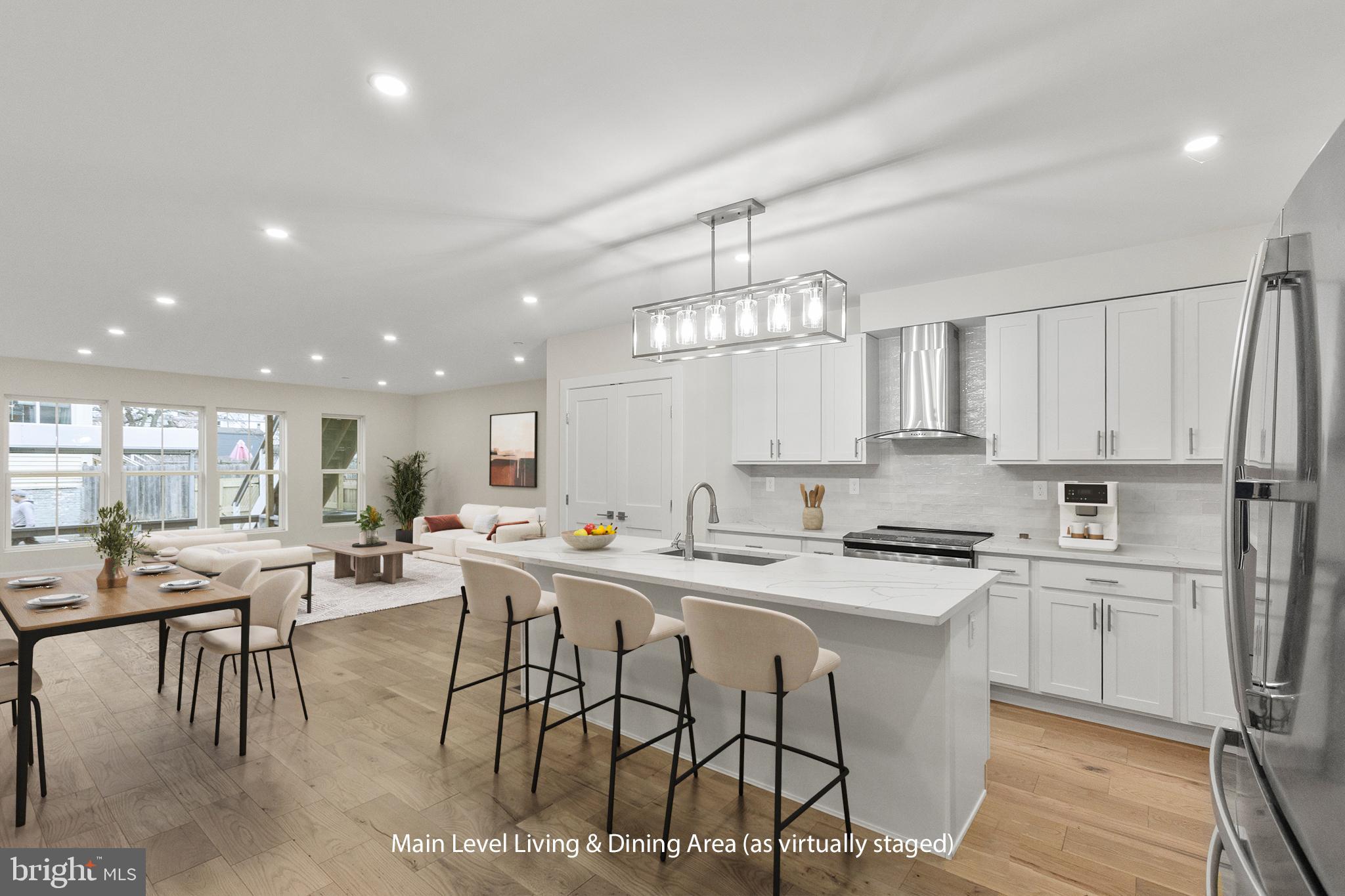 a kitchen with stainless steel appliances a table and chairs in it
