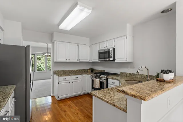 a view of a dining room with furniture large windows and wooden floor