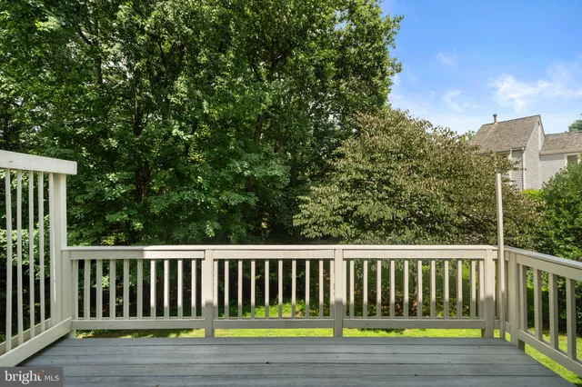 a picture of a bench in front of a wall