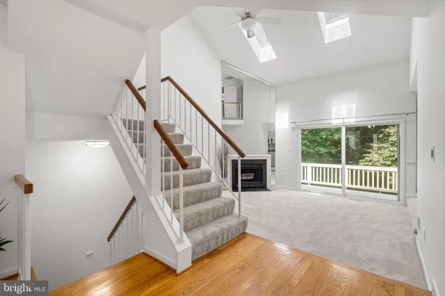 wooden floor fireplace and windows in an empty room