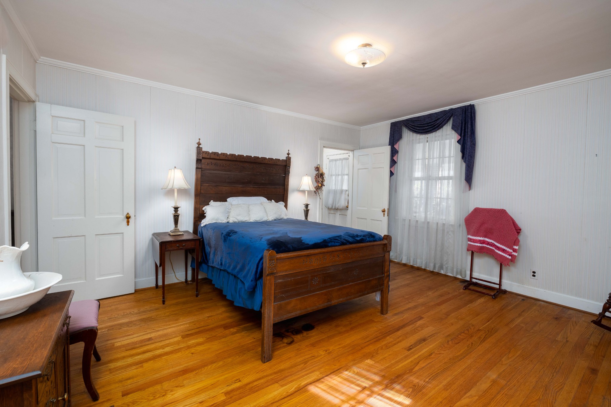 714 Murfreesboro Road Franklin, TN 37064 - Photo 15 of 46 a bedroom with a bed and wooden floor