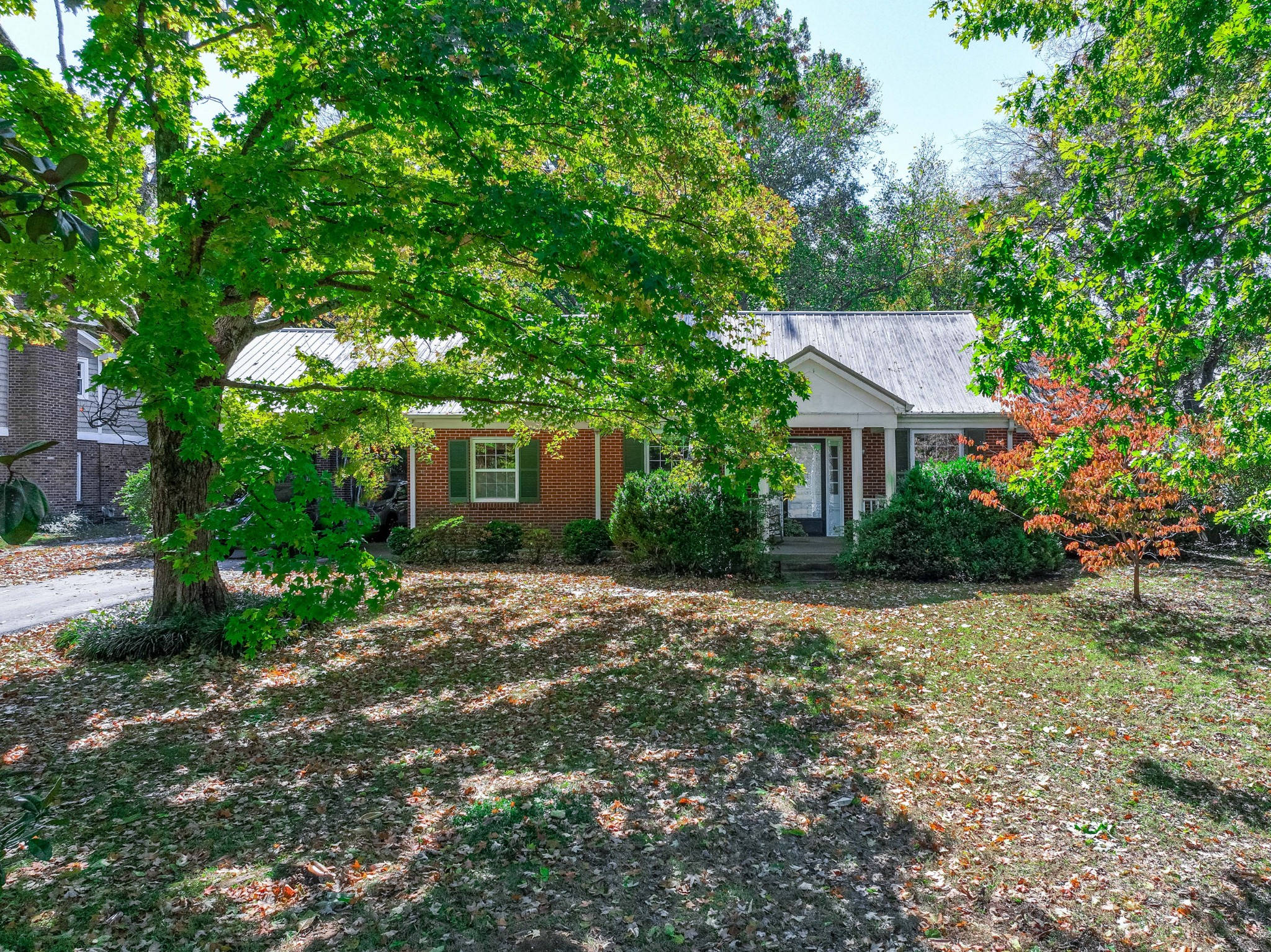 714 Murfreesboro Road Franklin, TN 37064 - Photo 37 of 46 a front view of a house with a yard and a tree