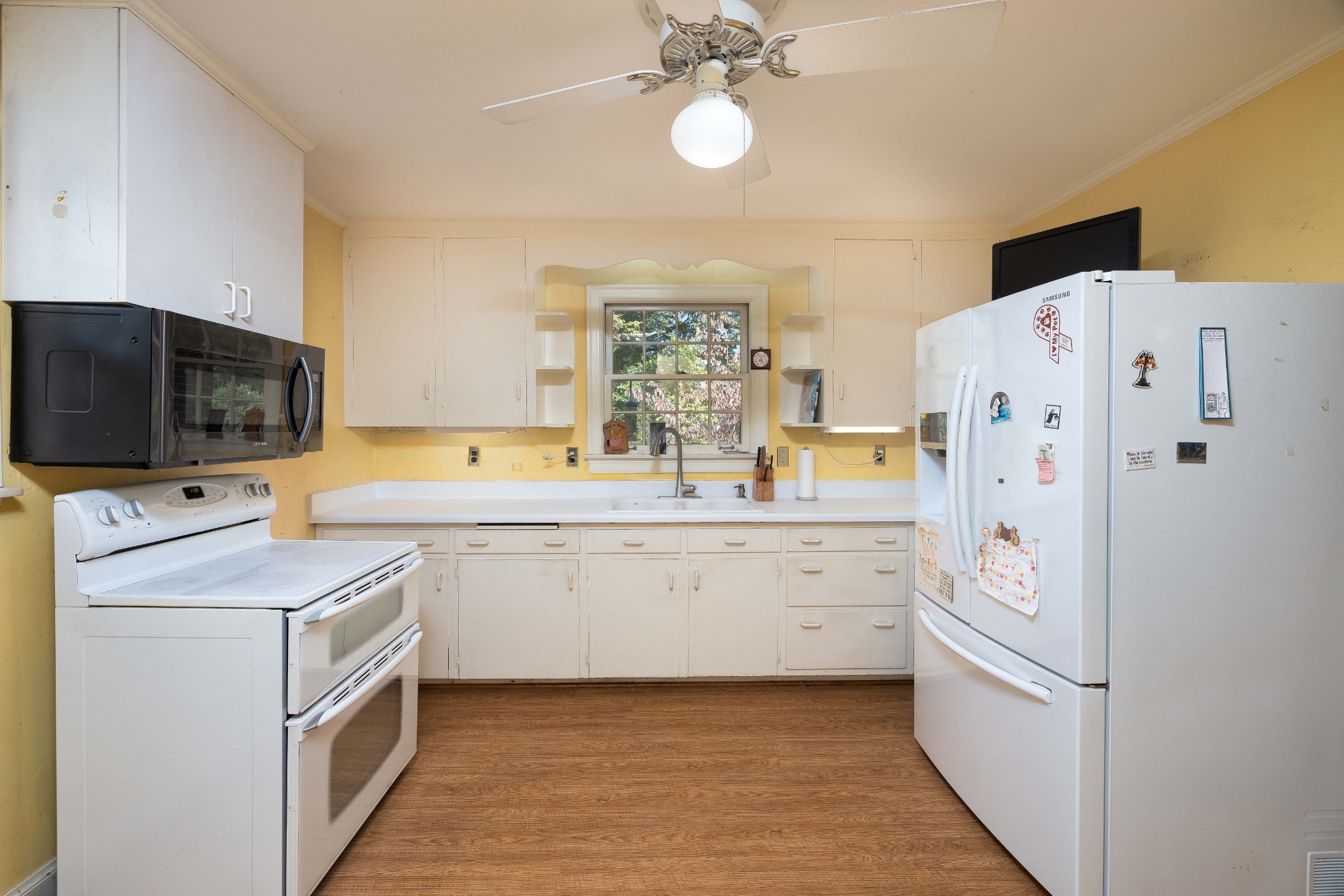 714 Murfreesboro Road Franklin, TN 37064 - Photo 7 of 46 a kitchen with white cabinets and stainless steel appliances
