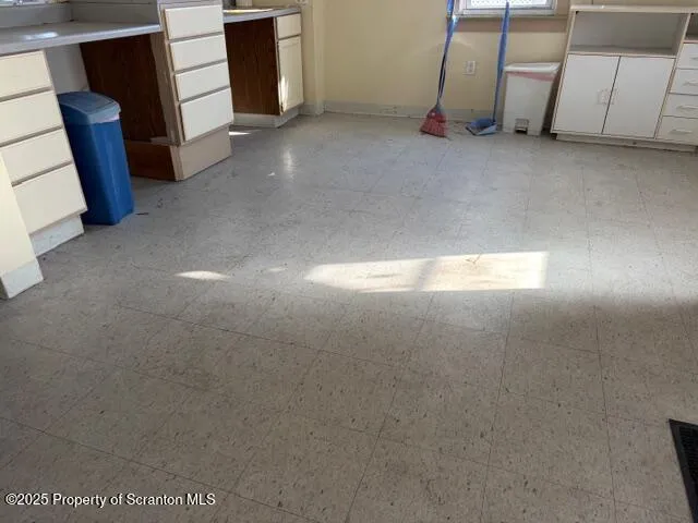 a view of empty room with staircase and dryer