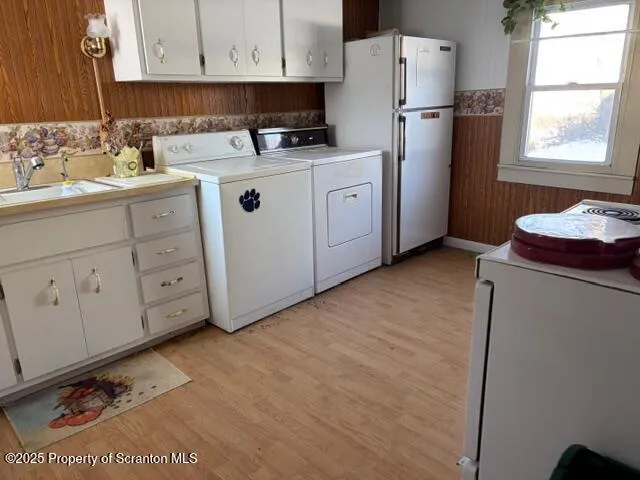 a kitchen with cabinets appliances a sink and a window