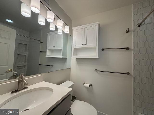 1312 Massachusetts Avenue Northwest, Unit 708 Washington, DC 20005 - Photo 17 of 34 a bathroom with a sink toilet vanity and shower