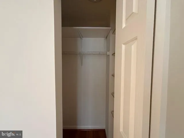 a kitchen with stainless steel appliances granite countertop a refrigerator a sink and white cabinets