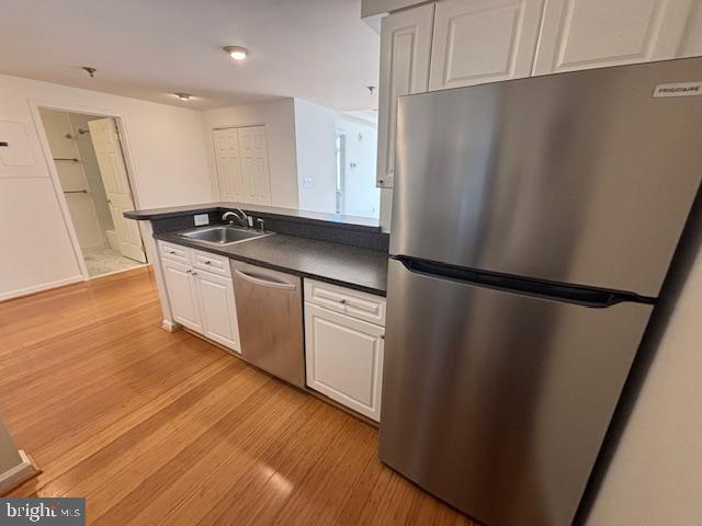 1312 Massachusetts Avenue Northwest, Unit 708 Washington, DC 20005 - Photo 24 of 34 a kitchen with stainless steel appliances granite countertop a refrigerator a sink and white cabinets