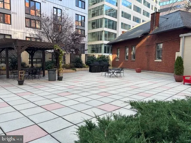 a view of a patio with table and chairs potted plants