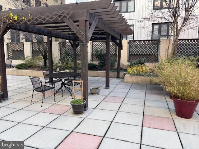 1312 Massachusetts Avenue Northwest, Unit 708 Washington, DC 20005 - Photo 30 of 34 a view of a patio with table and chairs potted plants