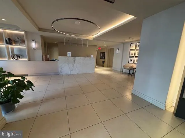 a view of a hallway with a couch and a potted plant