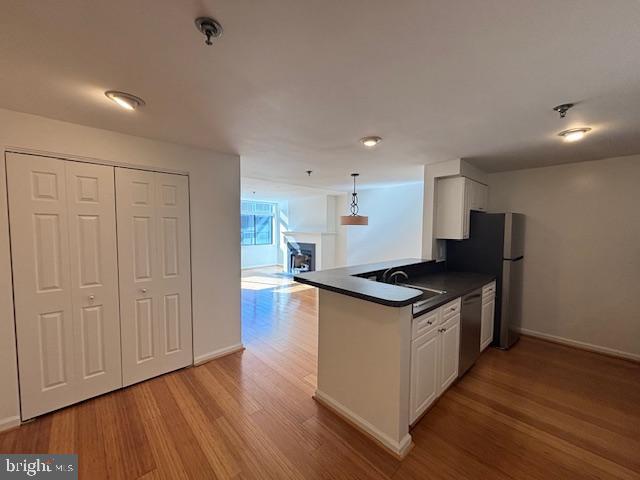 1312 Massachusetts Avenue Northwest, Unit 708 Washington, DC 20005 - Photo 7 of 34 a kitchen with stainless steel appliances granite countertop a stove and a wooden floors