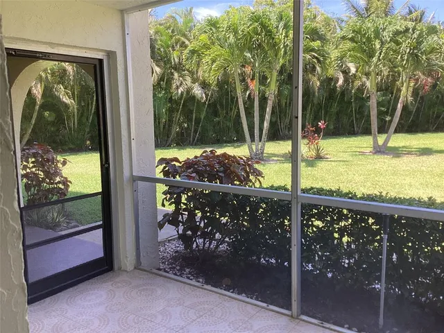 a view of a porch with a table and chairs