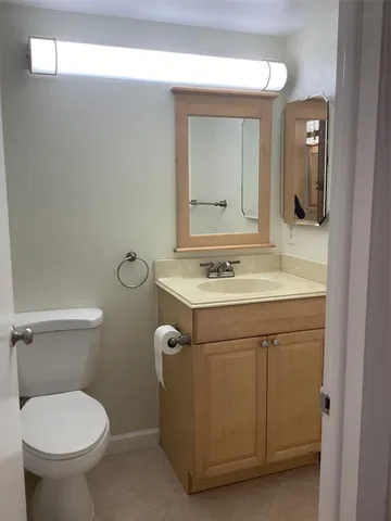 a bathroom with a sink toilet and mirror