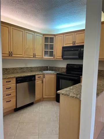 a kitchen with a stove and a sink