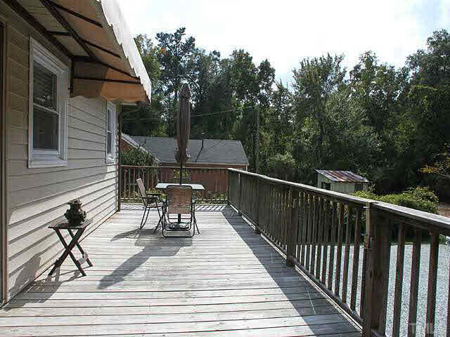 1337 Cole Mill Road Durham, NC 27705 - Photo 17 of 20 back deck offers a great view of the backyard. Door leads into the eat in kitchen. Patio/Deck