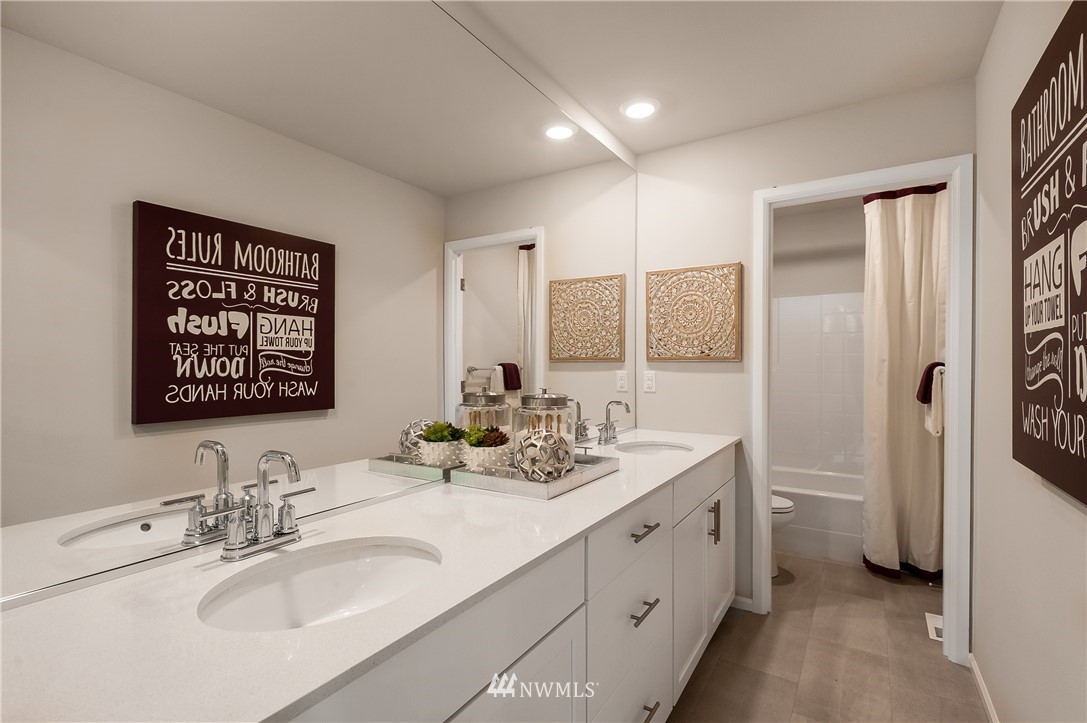 4110 235th Place Southeast, Unit 49 Bothell, WA 98021 - Photo 13 of 18 a bathroom with a double vanity sink mirror and double