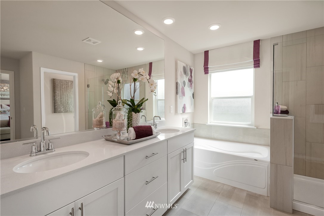 4110 235th Place Southeast, Unit 49 Bothell, WA 98021 - Photo 18 of 18 a bathroom with a double vanity sink window and a bathtub