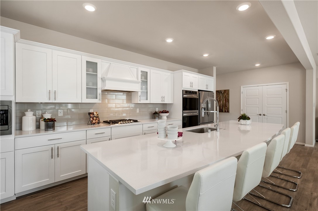 4110 235th Place Southeast, Unit 49 Bothell, WA 98021 - Photo 7 of 18 a kitchen with stainless steel appliances a sink a stove a refrigerator and cabinets