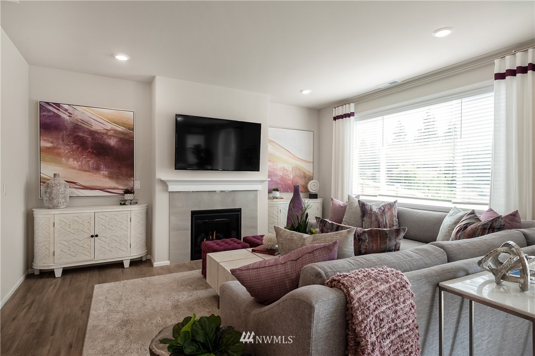4110 235th Place Southeast, Unit 49 Bothell, WA 98021 - Photo 9 of 18 a living room with furniture a flat screen tv and a fireplace