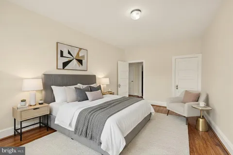 a bedroom with a bed and a lamp on table