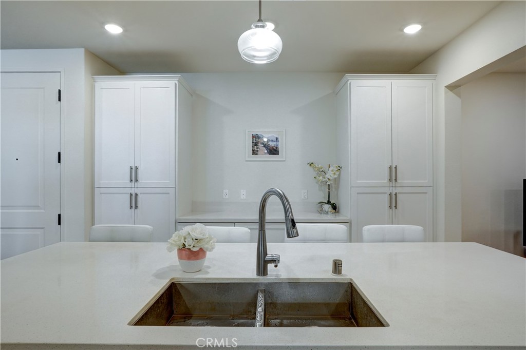 16235 Dawn Way, Unit 203 Tustin, CA 92782 - Photo 12 of 74 a kitchen with kitchen island a sink appliances and a counter top space