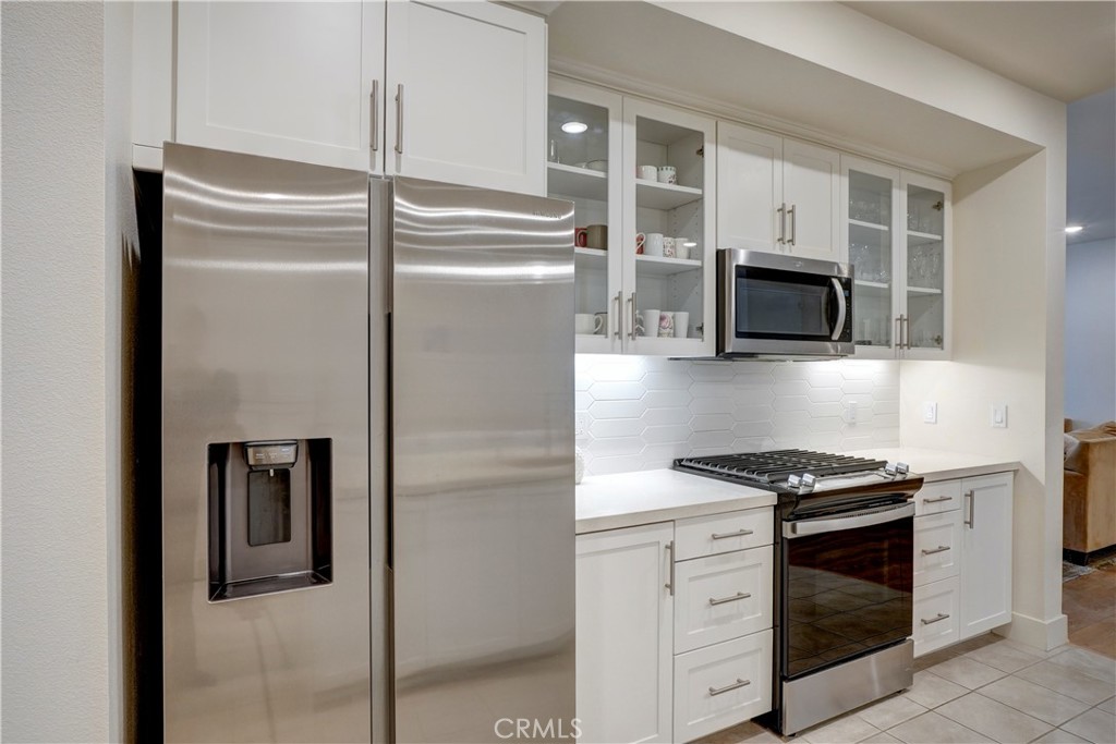 16235 Dawn Way, Unit 203 Tustin, CA 92782 - Photo 19 of 74 a kitchen with stainless steel appliances white cabinets and a stove