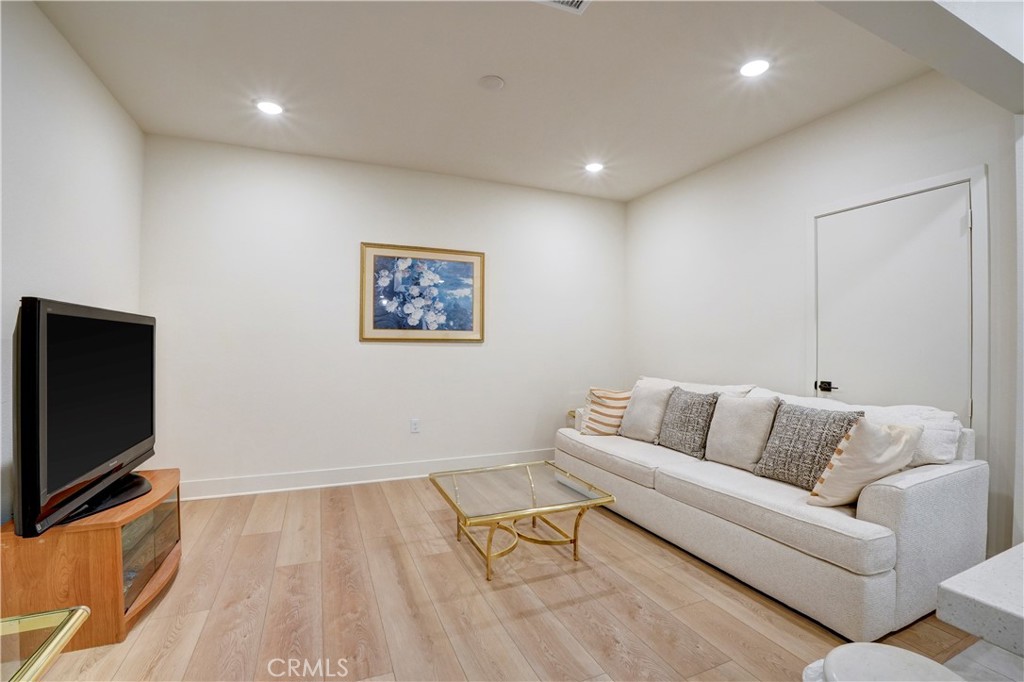 16235 Dawn Way, Unit 203 Tustin, CA 92782 - Photo 21 of 74 a living room with furniture and a flat screen tv