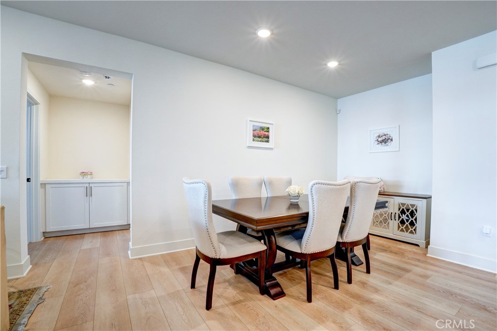 16235 Dawn Way, Unit 203 Tustin, CA 92782 - Photo 24 of 74 a view of a dining room with furniture and wooden floor