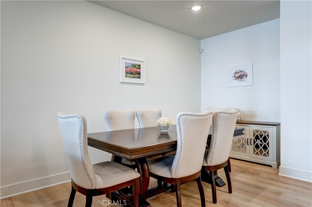 16235 Dawn Way, Unit 203 Tustin, CA 92782 - Photo 25 of 74 a view of a dining room with furniture and wooden floor