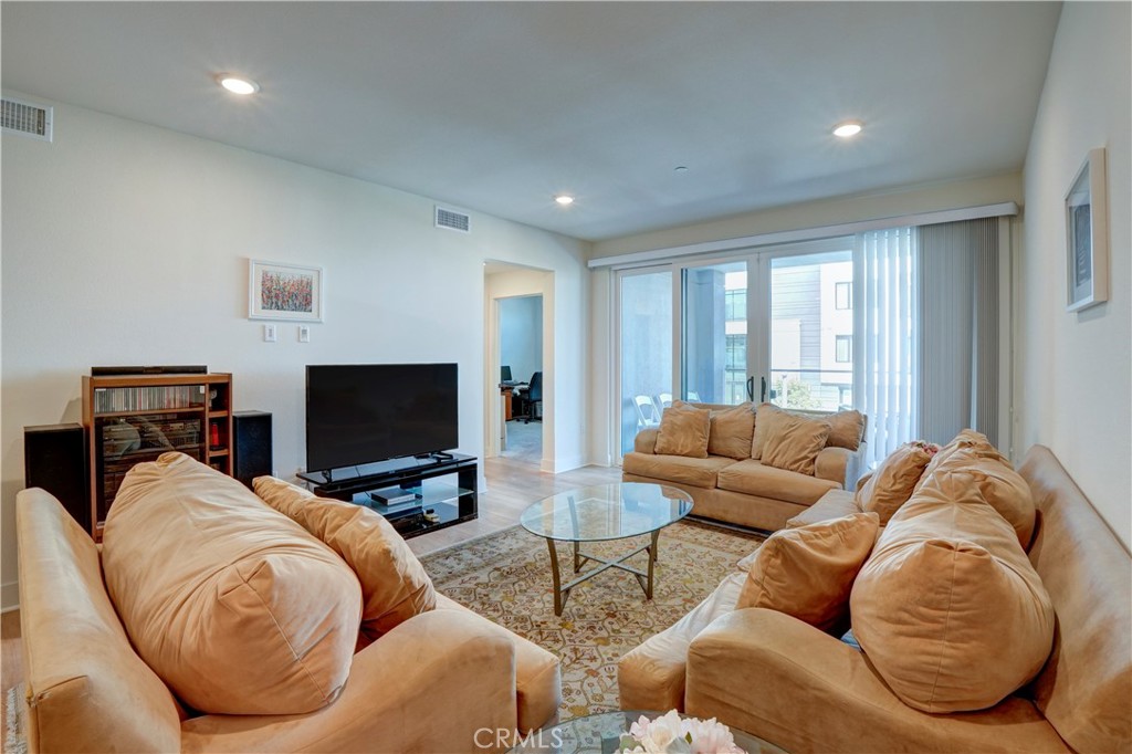 16235 Dawn Way, Unit 203 Tustin, CA 92782 - Photo 29 of 74 a living room with furniture and a flat screen tv