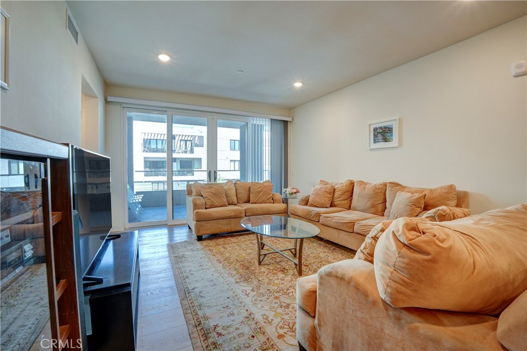 16235 Dawn Way, Unit 203 Tustin, CA 92782 - Photo 30 of 74 a living room with furniture and a flat screen tv