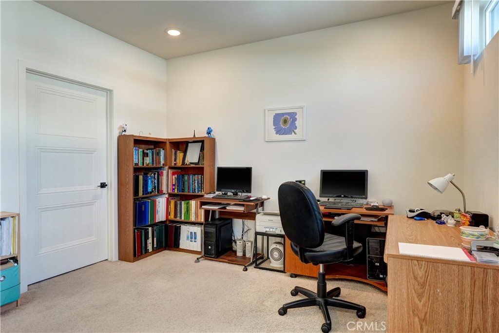 16235 Dawn Way, Unit 203 Tustin, CA 92782 - Photo 33 of 74 a view of a workspace with furniture and a bookshelf