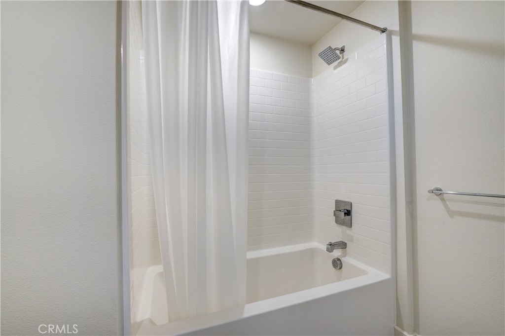 16235 Dawn Way, Unit 203 Tustin, CA 92782 - Photo 37 of 74 a bathroom with a shower and a bath tub