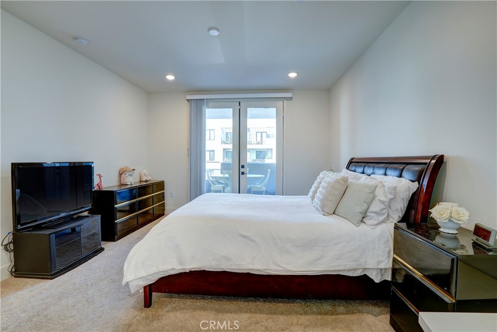 16235 Dawn Way, Unit 203 Tustin, CA 92782 - Photo 39 of 74 a bedroom with a bed and a television