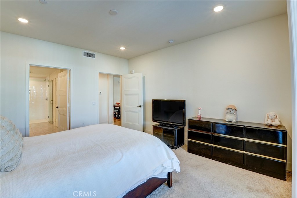 16235 Dawn Way, Unit 203 Tustin, CA 92782 - Photo 40 of 74 a bedroom with a bed and a flat screen tv