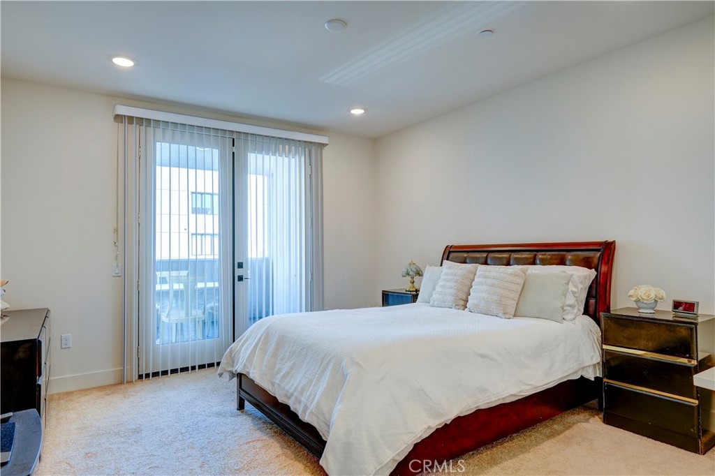 16235 Dawn Way, Unit 203 Tustin, CA 92782 - Photo 41 of 74 a spacious bedroom with a bed and a window