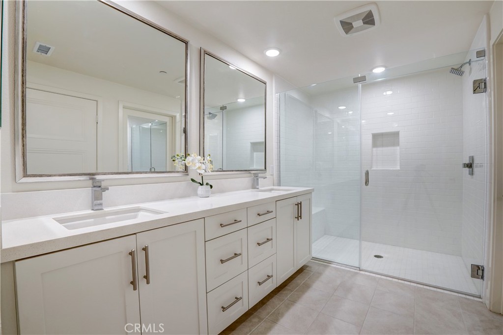 16235 Dawn Way, Unit 203 Tustin, CA 92782 - Photo 45 of 74 a bathroom with double sink and a mirror