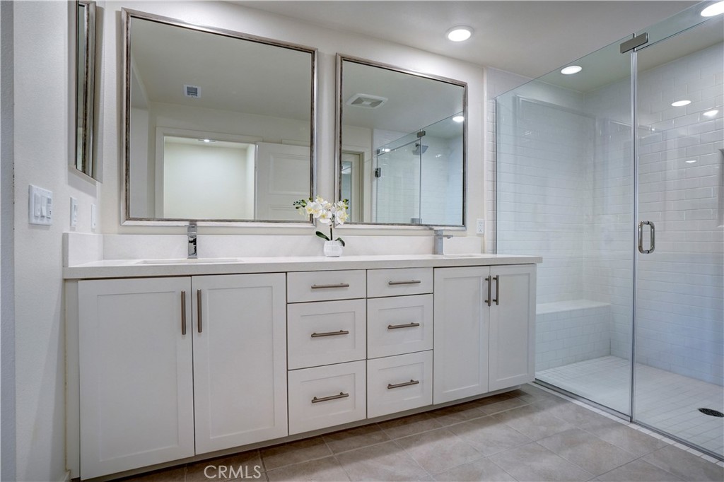 16235 Dawn Way, Unit 203 Tustin, CA 92782 - Photo 47 of 74 a bathroom with a sink and a mirror
