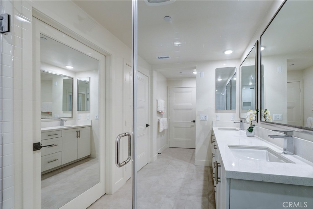 16235 Dawn Way, Unit 203 Tustin, CA 92782 - Photo 51 of 74 a bathroom with a double vanity sink mirror and shower