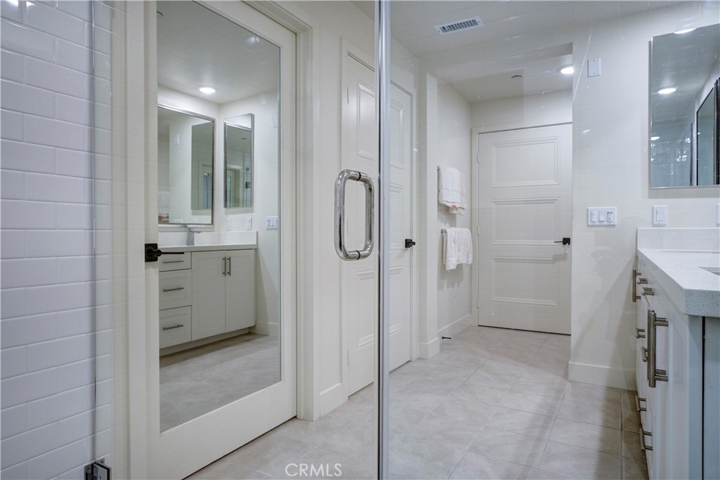 16235 Dawn Way, Unit 203 Tustin, CA 92782 - Photo 52 of 74 a bathroom with a shower and a glass door