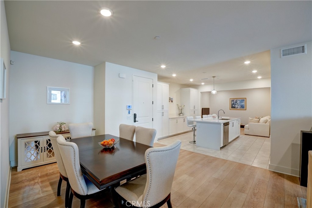 16235 Dawn Way, Unit 203 Tustin, CA 92782 - Photo 9 of 74 a living room with furniture a wooden floor and a flat screen tv