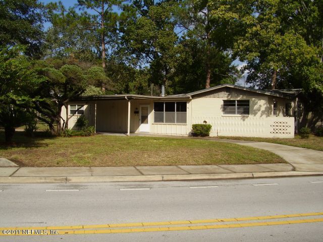 4703 Spring Park Road Jacksonville, FL 32207 - Photo 1 of 14 a house with trees in front of it