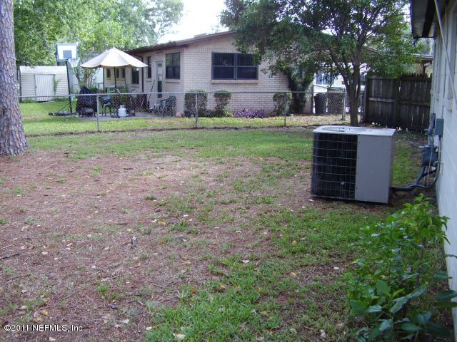 4703 Spring Park Road Jacksonville, FL 32207 - Photo 14 of 14 a view of a house with backyard and trees