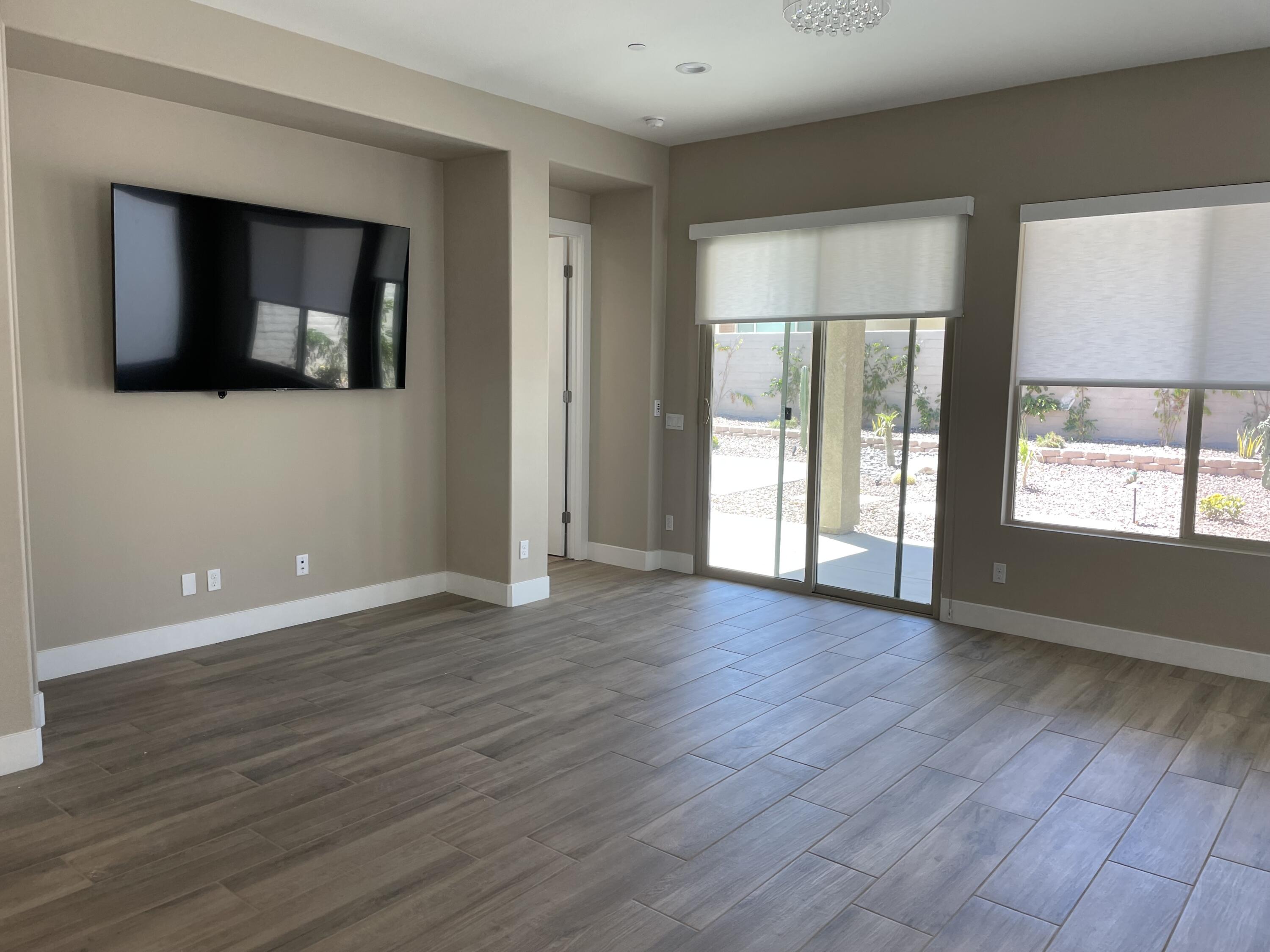 35 Semillon Rancho Mirage, CA 92270 - Photo 2 of 13 an empty room with wooden floor and windows