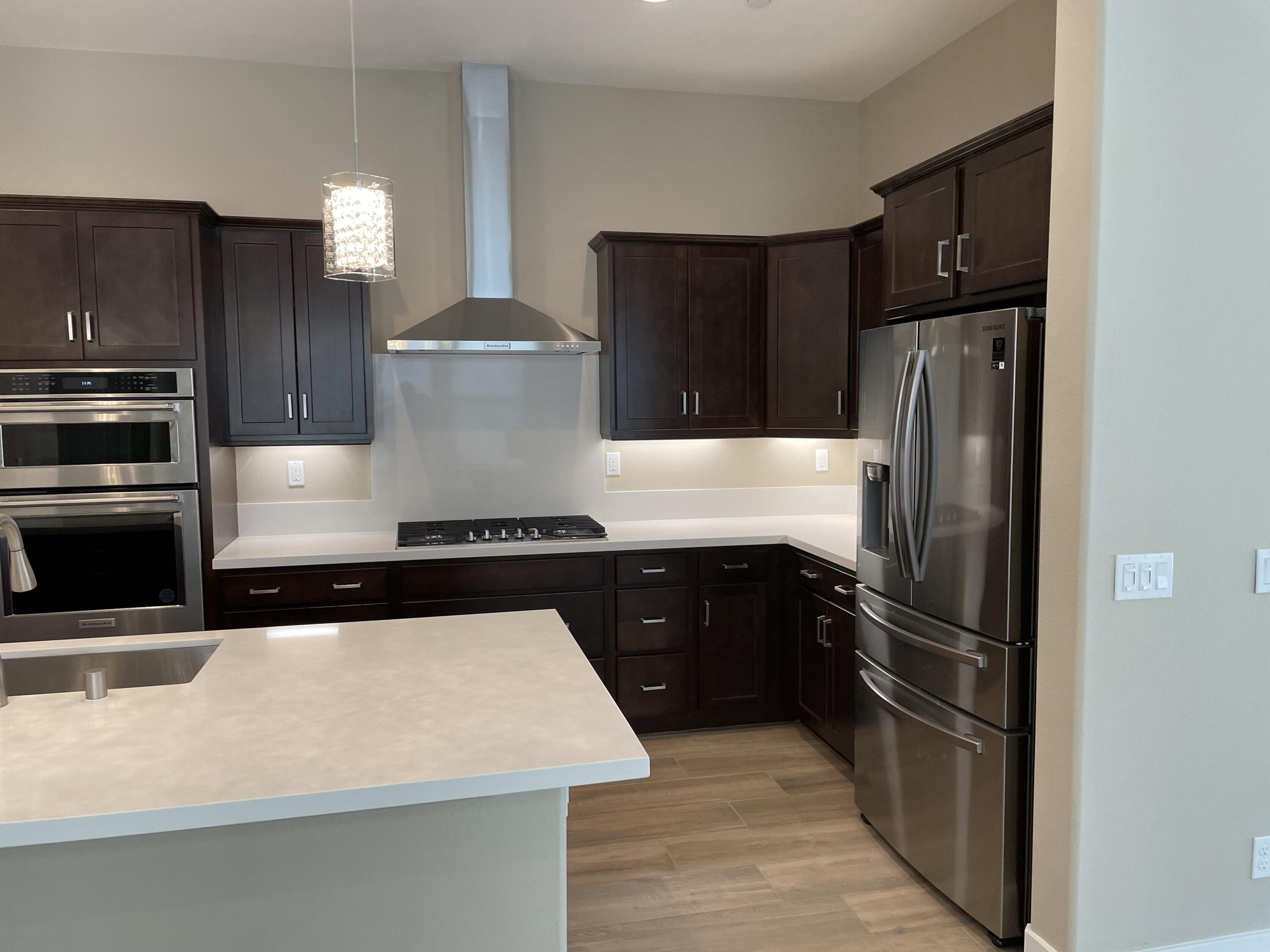 35 Semillon Rancho Mirage, CA 92270 - Photo 4 of 13 a kitchen with a refrigerator and a stove top oven