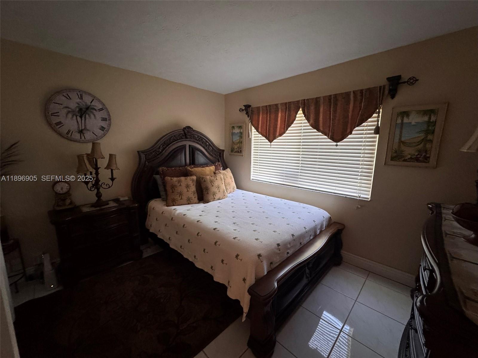 705 Southeast 3rd Lane Dania Beach, FL 33004 - Photo 12 of 15 a bedroom with a bed and a chandelier