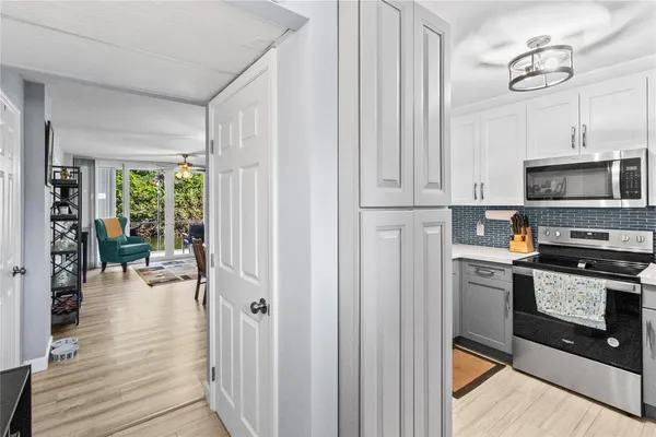 a kitchen with stove and cabinets