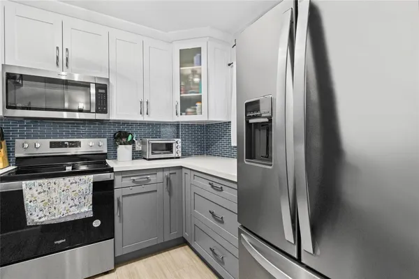 a kitchen with stainless steel appliances granite countertop a refrigerator sink and stove